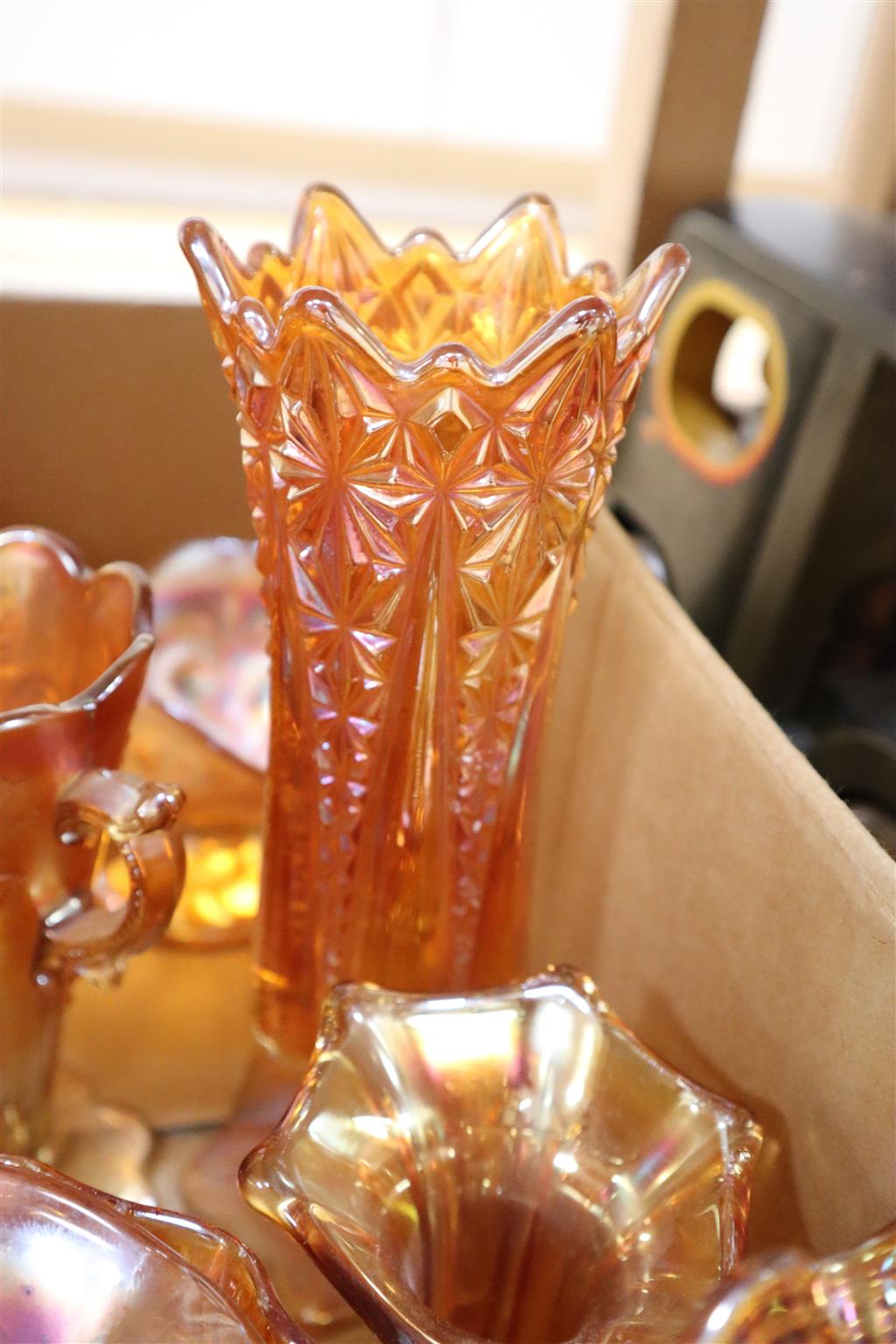 A quantity of orange carnival glass dishes, vases etc